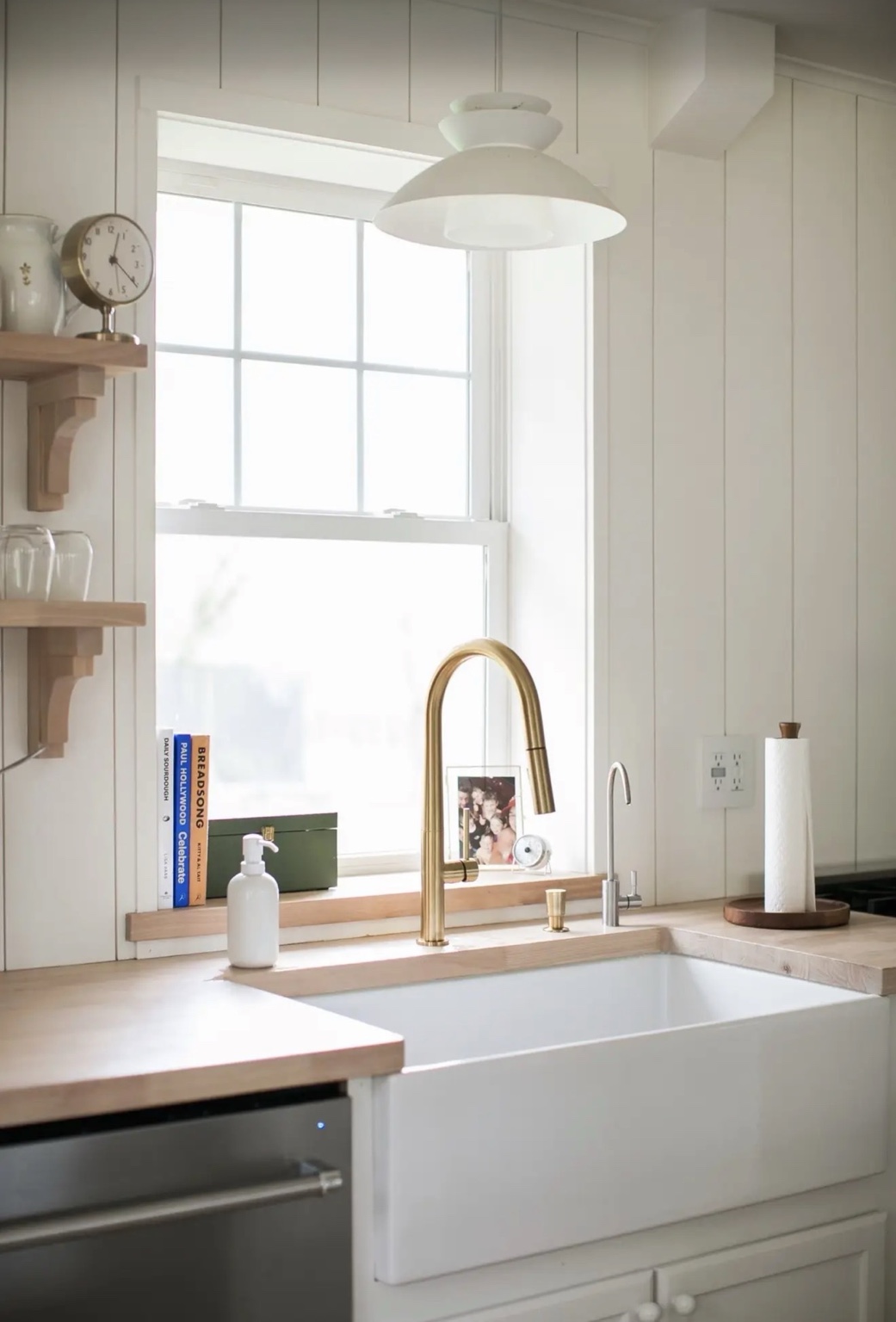 Farmhouse sink, brass faucet and natural wood counters in a Bahrke Built kitchen
